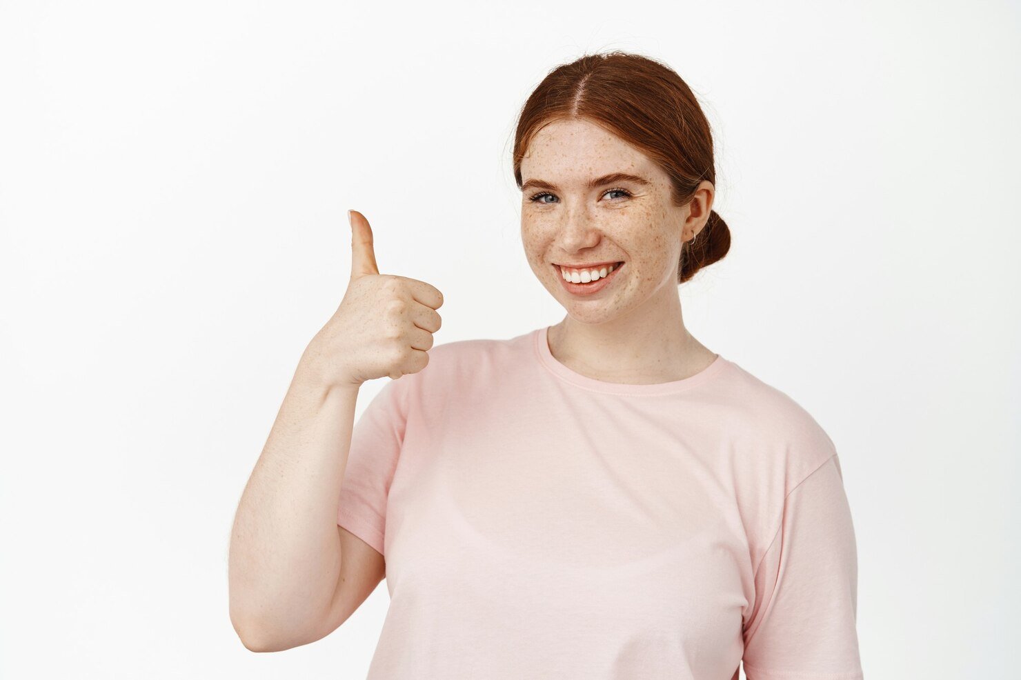 portrait-caucasian-redhead-girl-shows-thumb-up-smiles-pleased-support-your-idea-praise-compliment-like-something-good-positive-feedback-standing-white_176420-40770